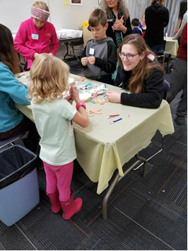 Karoline Tyne helping kid build gingerbread house